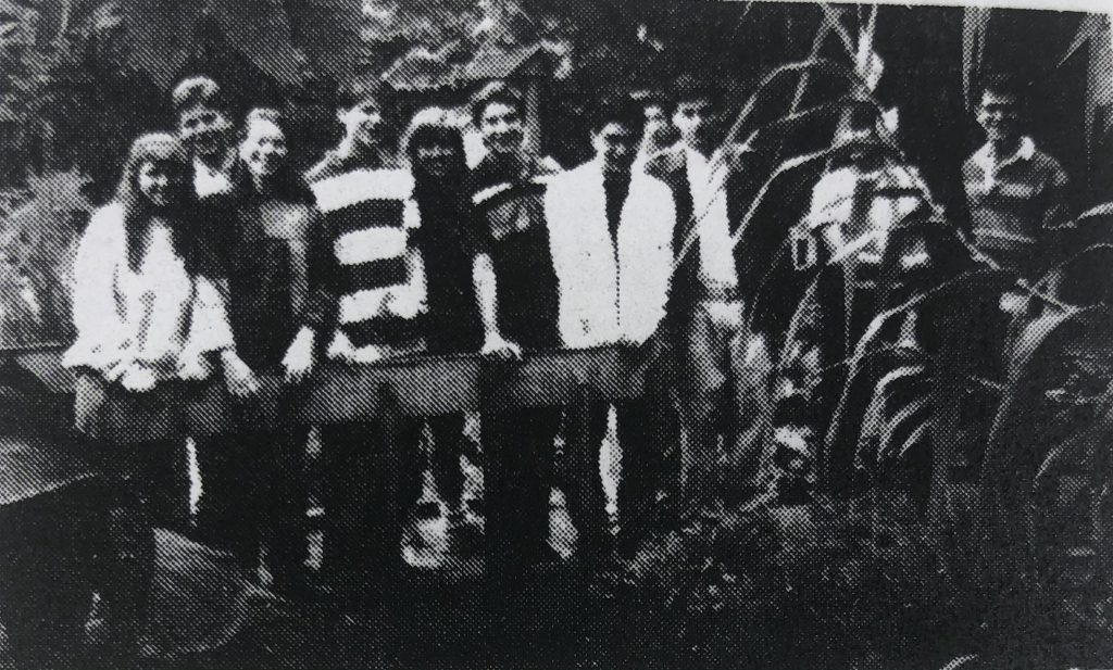 group of 11people outside smiling in black and white