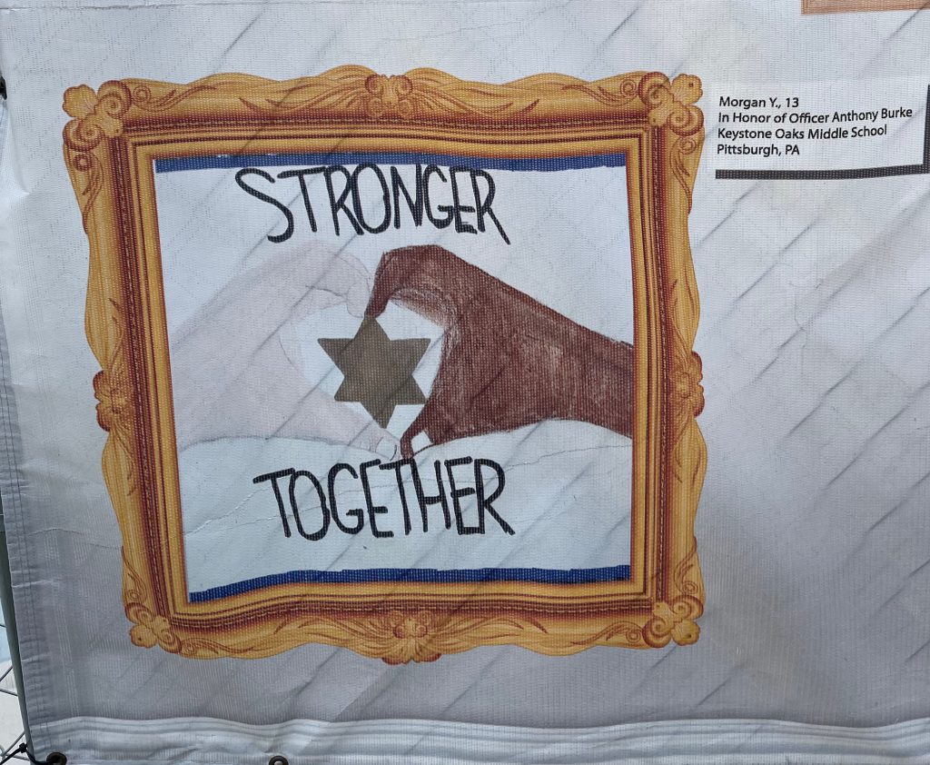 drawing by Morgan shows two hands holding the Star of David with the words Stronger Together